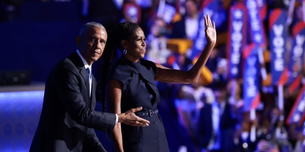 former-u-s-president-barack-obama-l-gestures-to-former-first-lady-michelle-obama-as-he-arrives-to-speak-on-stage-during-the-s.jpg