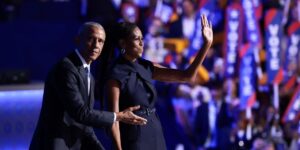 former-u-s-president-barack-obama-l-gestures-to-former-first-lady-michelle-obama-as-he-arrives-to-speak-on-stage-during-the-s.jpg