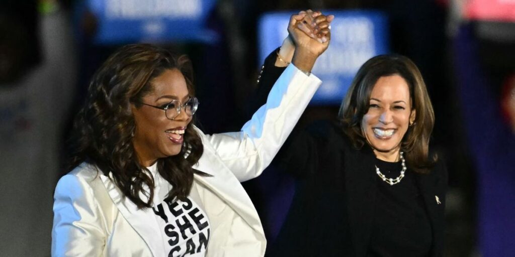 oprah-winfrey-l-holds-up-us-vice-president-and-democratic-presidential-candidate-kamala-harris-hand-as-she-arrive-onstage-dur.jpg