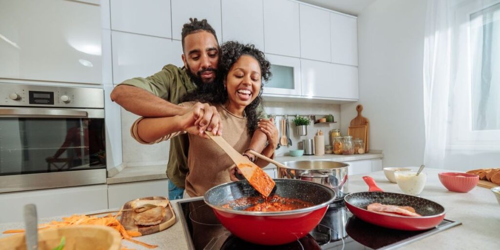 a-young-black-couple-playfully-cooking-at-home.jpg