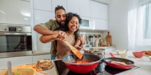 a-young-black-couple-playfully-cooking-at-home.jpg