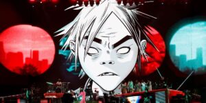 a-band-performs-on-a-large-stage-with-a-screen-displaying-the-classic-gorillaz-lead-singer-in-the-background.jpg
