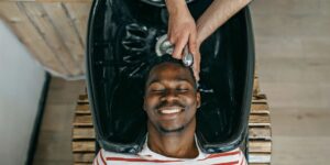 a-smiling-black-man-has-his-hair-washed-at-the-barber.jpg