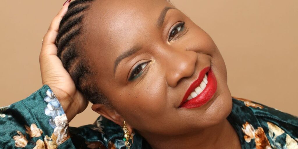 a-smiling-black-woman-with-her-hair-in-braids-and-bright-red-lipstick.jpg