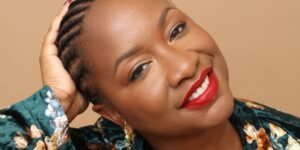 a-smiling-black-woman-with-her-hair-in-braids-and-bright-red-lipstick.jpg