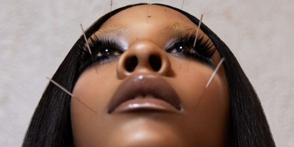 a-close-up-of-rico-nasty-with-acupuncture-needles-in-her-face.jpg