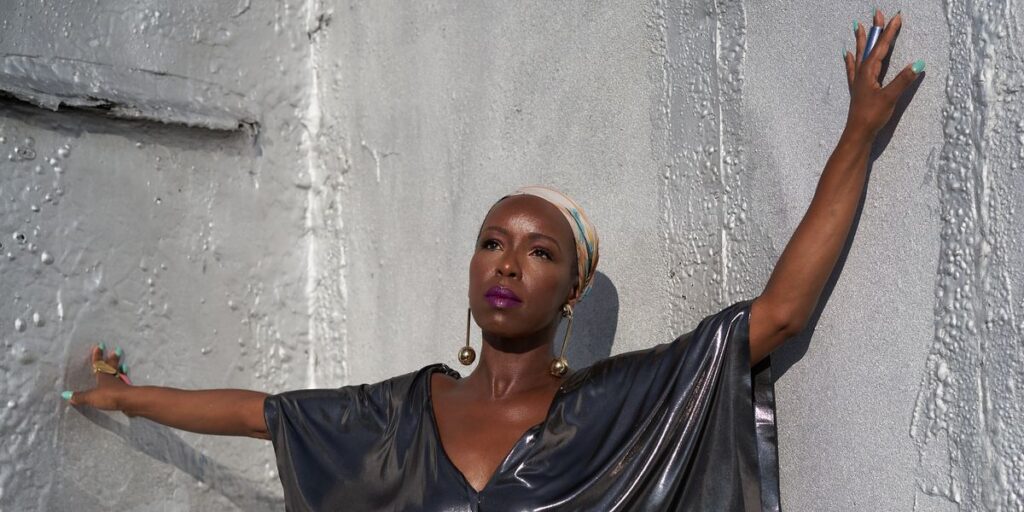 dj-reborn-with-a-headwrap-and-her-hands-up.jpg