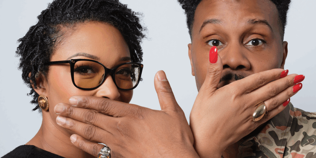 two-people-stand-posing-with-their-hands-playfully-covering-each-other-s-mouth.png