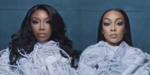 brandy-and-monica-wearing-what-look-like-straightjackets-tied-up-with-microphone-chords.jpg