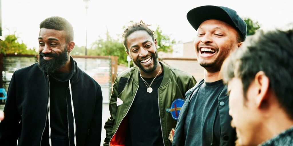 laughing-friends-in-discussion-while-hanging-out-at-outdoor-bar.jpg