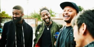 laughing-friends-in-discussion-while-hanging-out-at-outdoor-bar.jpg