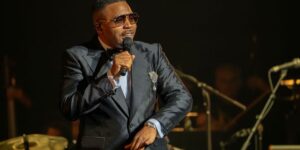 a-perfomer-in-a-black-suit-holds-a-microphone-and-sings.jpg